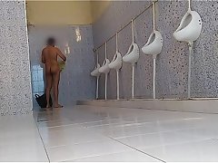 Indian male stripping nude in public restroom